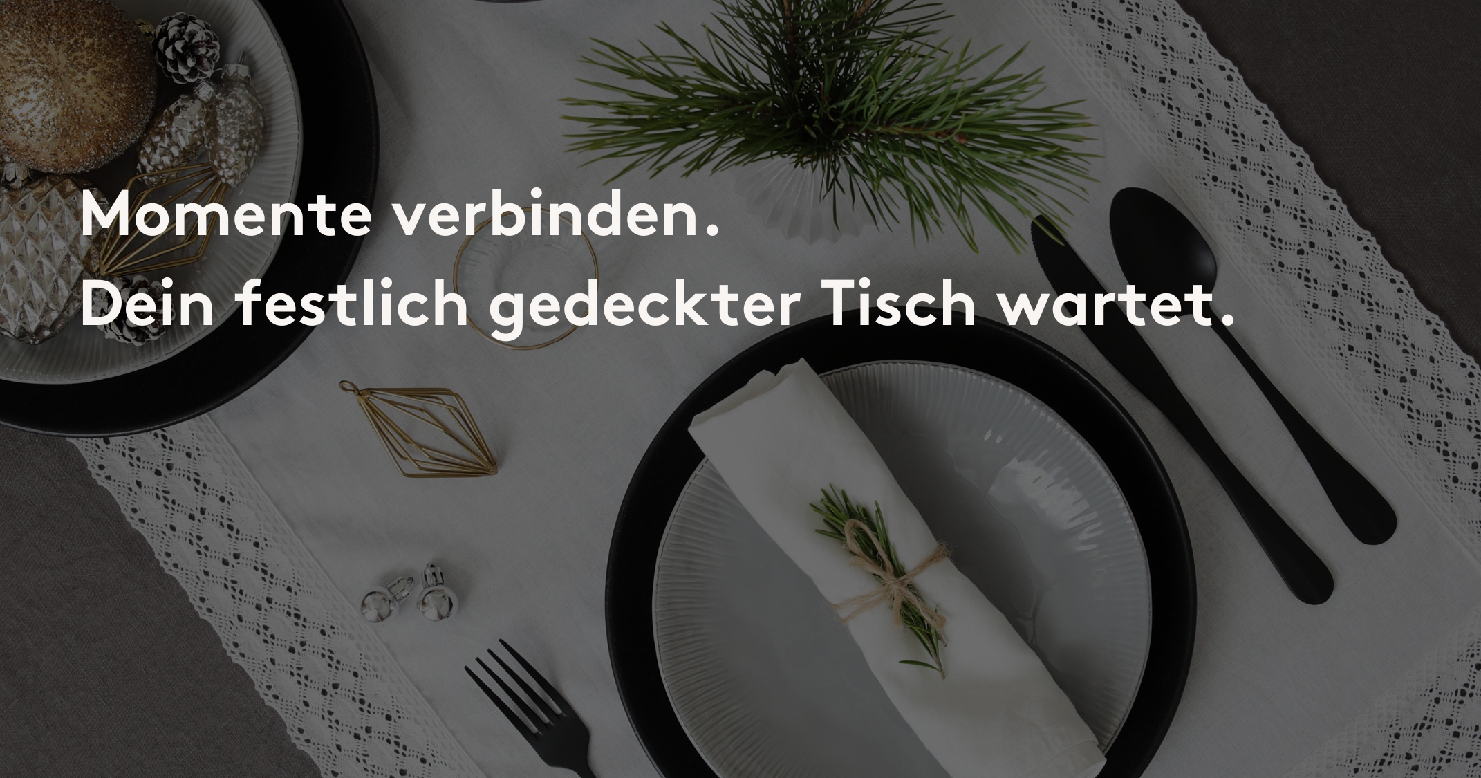 Festlich gedeckter Tisch mit weißem Geschirr, Besteck, Stoffserviette und Tannenzweig auf Tischdecke.