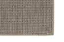 Nahaufnahme einer beigen Outdoor-Teppich-Ecke mit strukturierter, gewebter Oberfläche und eingefasstem Rand.