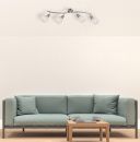 Modernes Wohnzimmer mit hellgrünem Sofa, Holztisch und silberner Deckenlampe mit vier Strahlern.