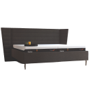 Modernes Boxspringbett mit hohem, gepolstertem Kopfteil, zwei TEMPUR-Matratzen und Nachttischdeko.