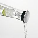Glaskaraffe mit Edelstahl-Deckel, Eiswu00fcrfeln und Limettenscheiben, gieu00dft frisches Wasser aus, minimalistisch.