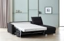 Schwarzes Schlafsofa mit ausgeklappter Matratze in modernem Wohnzimmer mit hellgrüner Wand und Dekoration.