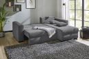 Graues Schlafsofa im modernen Wohnzimmer mit Teppich, Kissen, Decke und grou00dfen Fenstern mit Gartenblick.