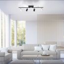 Moderne Wohnzimmer-Einrichtung mit beiger Couch, Couchtisch und schwarzer Deckenlampe im minimalistischen Stil.