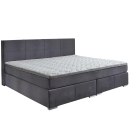 Modernes Boxspringbett mit grauem Stoffbezug und gepolstertem Kopfteil, komfortable Matratze, Schlafzimmermöbel.