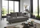 Modernes Wohnzimmer mit grauem Sofa, Couchtisch, großen Fenstern und stilvoller, minimalistischer Dekoration.