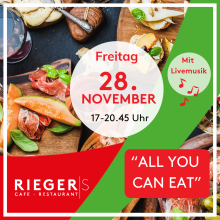 All-you-can-eat Buffet mit Livemusik im Riegers Café Restaurant am 28. November, verschiedene Speisen auf Holzbrettern.