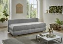 Modernes Wohnzimmer mit grauem Sofa, Couchtisch, Pflanzen und großen Fenstern mit Blick ins Grüne.