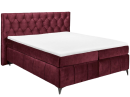 Modernes Boxspringbett in Bordeaux-Rot mit gestepptem Kopfteil und weißer Matratze auf Holzfüßen.